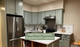 Sage Green Kitchen Cabinets and White Countertops Modernize a San Francisco Unit  Sage Green Kitchen Cabinets and White Countertops Modernize a San Francisco Unit